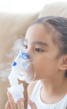 Image of young girl using respiratory device